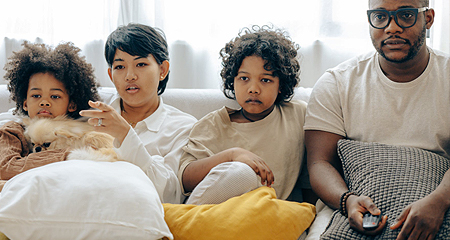 Family watching a movie.