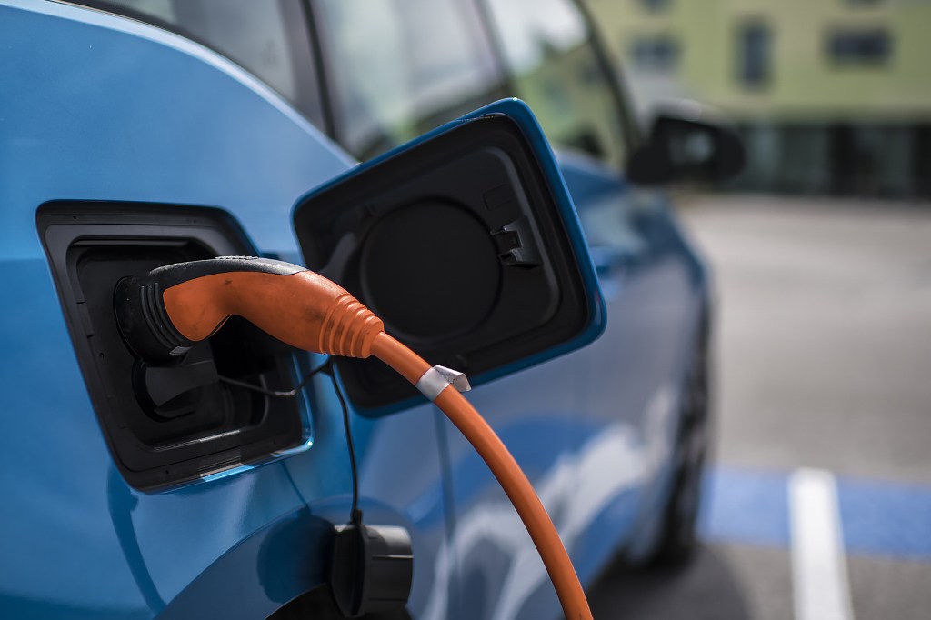 Electric car plugged into a charging station.