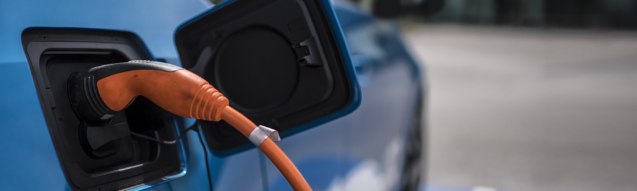 EV car plugged into a charging station.